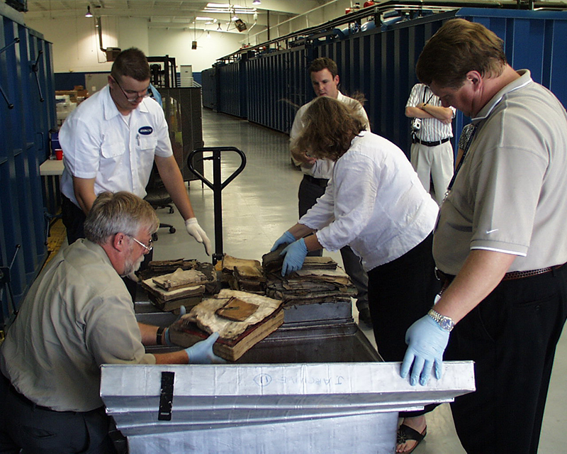 ija-the-national-archives-staff-examines-items-in-the-frozen-collection-up — page 1 · Iraqi Jewish Archive (NARA) · judeoiraq.org