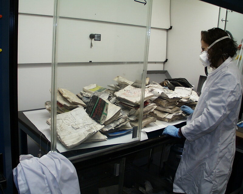 ija-sorting-the-damaged-books-and-documents-in-a-fume-hood — page 1 · Iraqi Jewish Archive (NARA) · judeoiraq.org